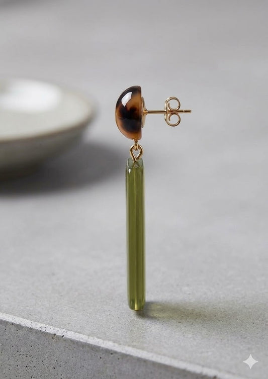 A pair of Soloviera dangle earrings featuring a polished tortoiseshell resin sphere post, connected by small gold-tone links to a long, semi-translucent olive green rectangular prism drop.